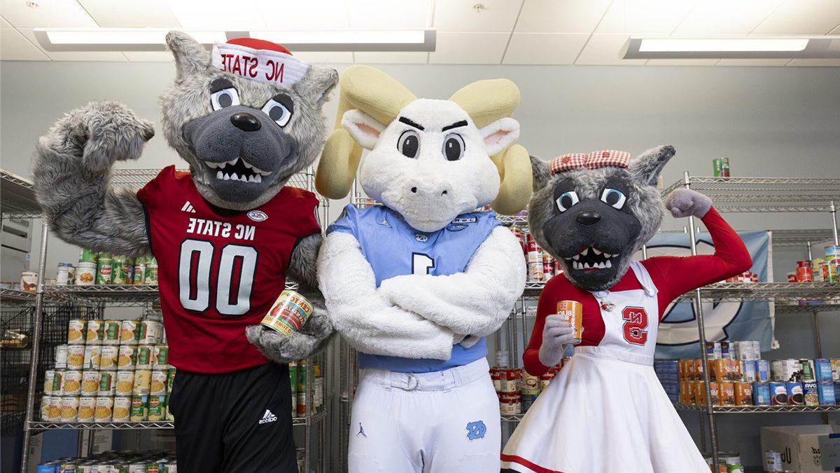 N.C. State mascots Mr. and Mrs. Wulf with U.N.C. mascot Rameses.